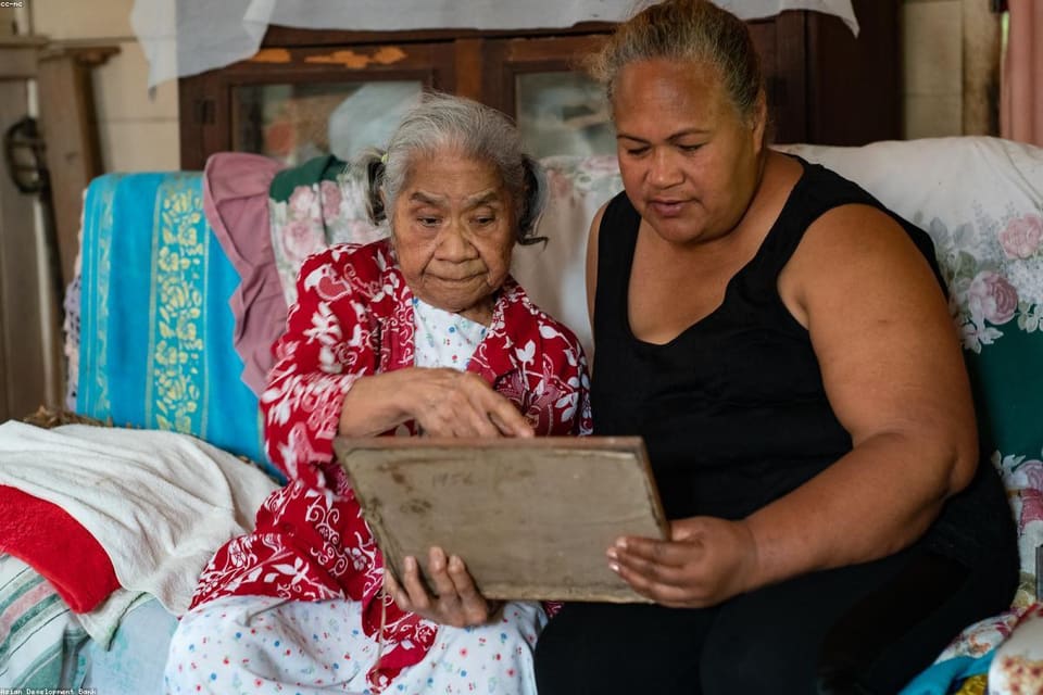 Care worker supporting an older person in a home environment