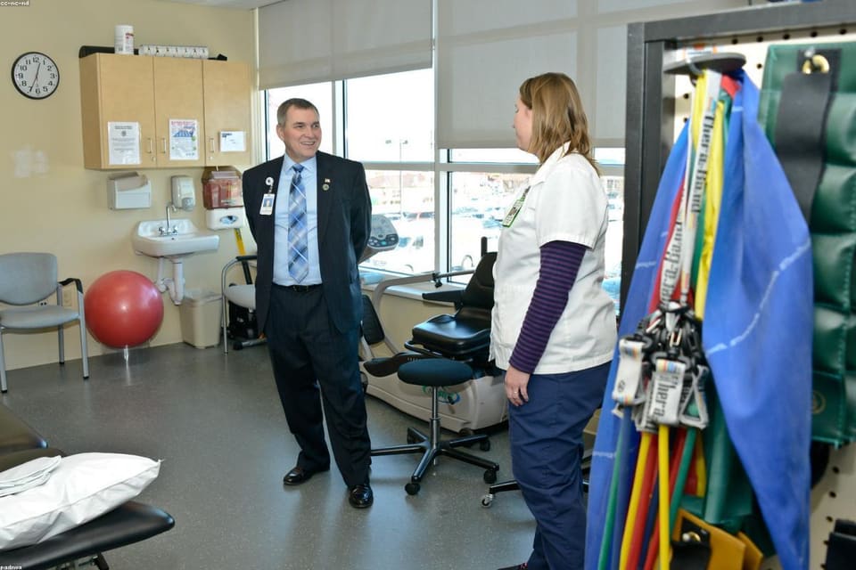 Care worker assisting with mobility support at home